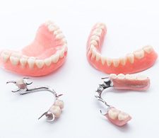 Full and partial dentures on white background