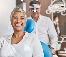 Patient and dentist smiling in treatment room