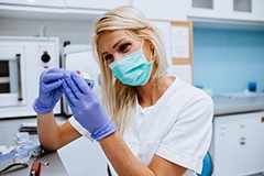 Dentist in Waterbury checking dentures