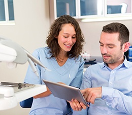 A dentist explaining gum disease risk factors to her patient