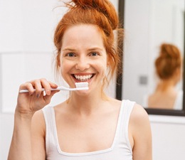 Woman with toothbrush about to brush teeth