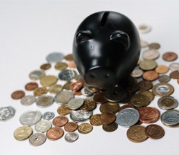 Black piggy bank and loose coins