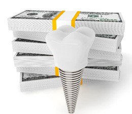 Model dental implant standing in front of stacks of money