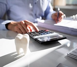 A man calculating the cost of root canal therapy