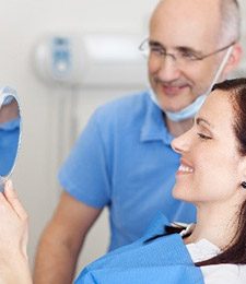 Woman looking at smile in mirror