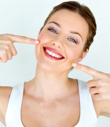 Smiling woman pointing to her mouth