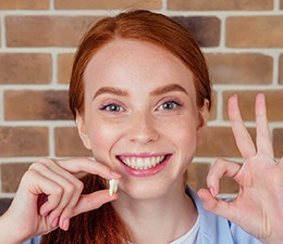 Woman holding a wisdom tooth