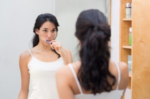 woman brushing her teeth