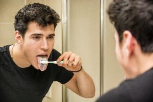 man brushing his teeth