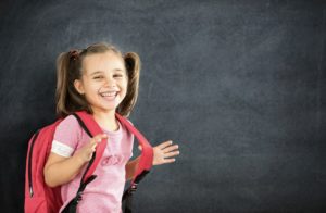 Young girl by chalkboard