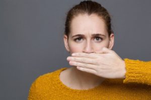 Woman embarrassed by her bad breath at dentist in Waterbury.