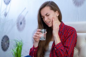 Woman with sensitive teeth due to overaggressive brushing