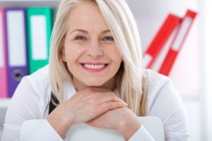 Older woman smiling after dentist in Waterbury.