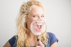 Woman smiling while extending the lifespan of veneers