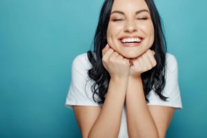 young woman showing off her smile after getting dental bonding 