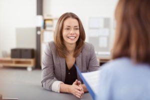 woman in a job interview after getting teeth whitening 