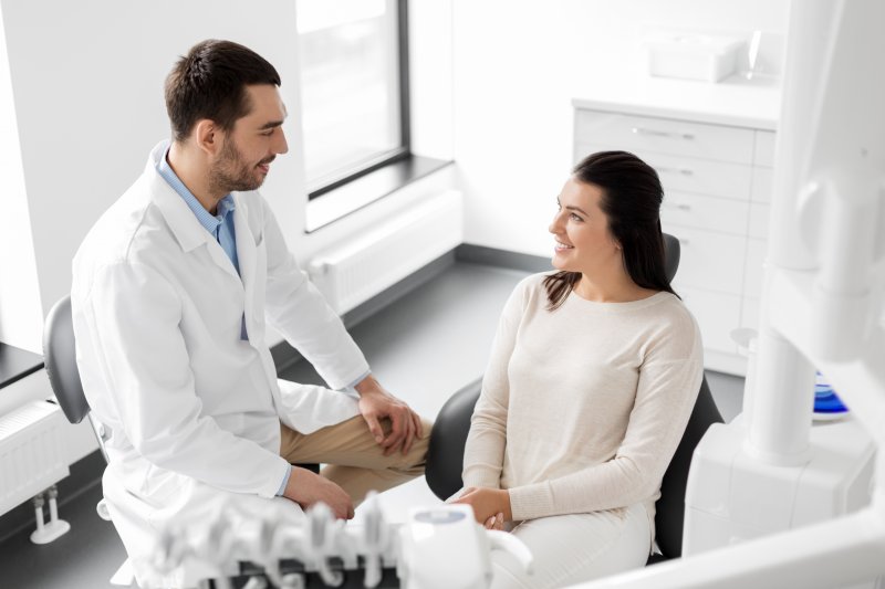 person speaking with dentist about signs of dehydration