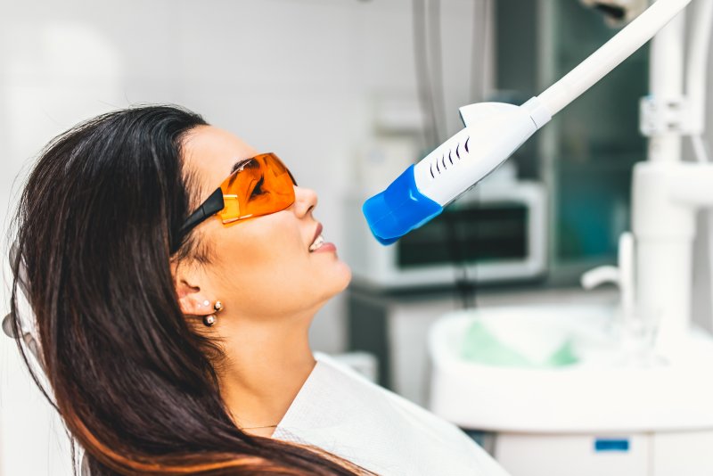 person with stained teeth having them whitened by dentist