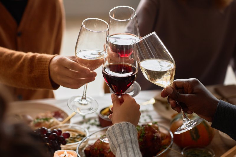 A group of friends with good oral health enjoying holiday wine