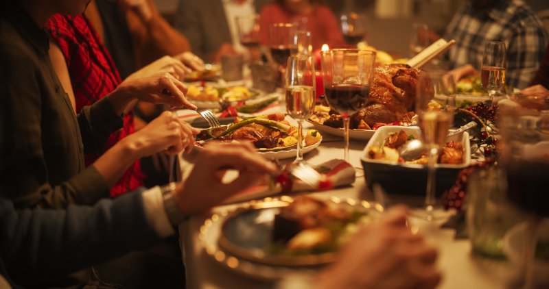 A group of friends with good oral health enjoying a holiday spread 