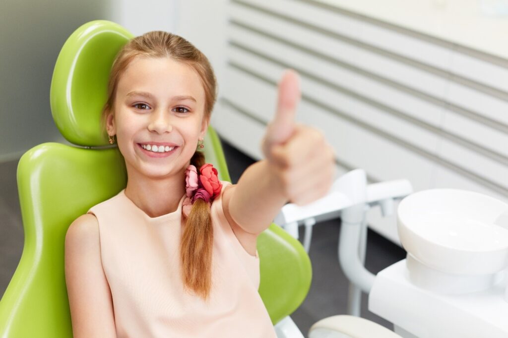 child at dentist to get dental crown